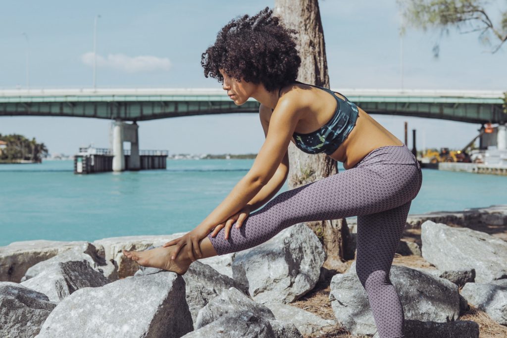 Black girl working out on riverbank